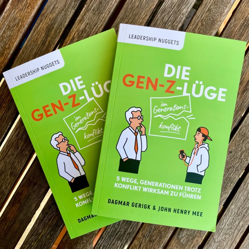 Buch die Gen-Z-Lüge von Dagmar Gerigk, John Henry Mee Buch die Gen-Z-Lüge von Dagmar Gerigk, John Henry Mee auf Holztisch
