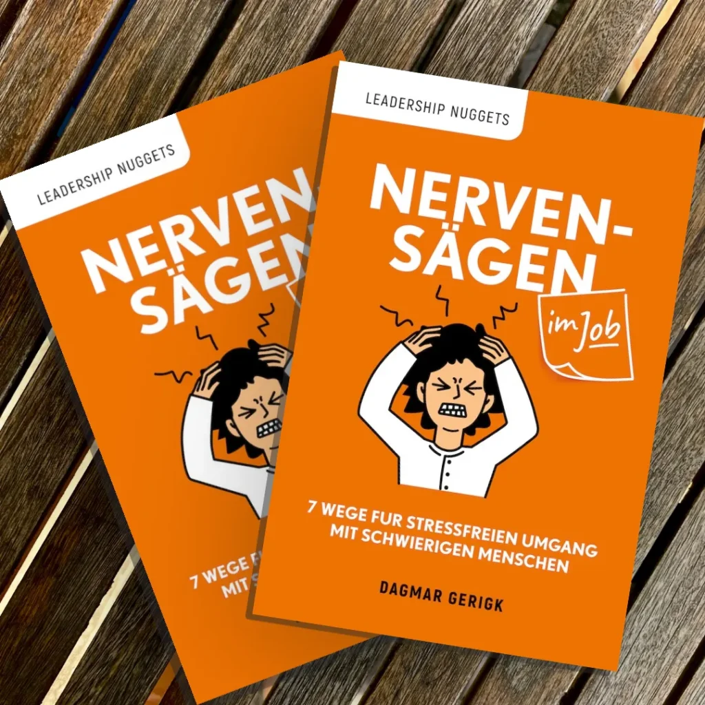 Buch Nervensägen im Job auf Holztisch